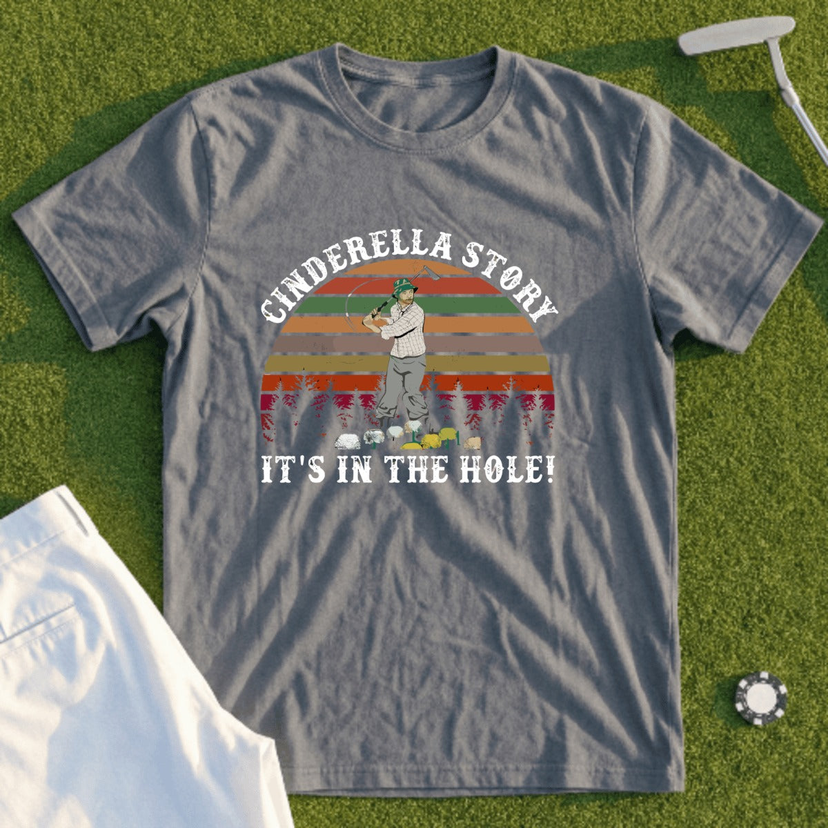 T-shirt with "Cinderella Story It's In The Hole!" golf graphic.