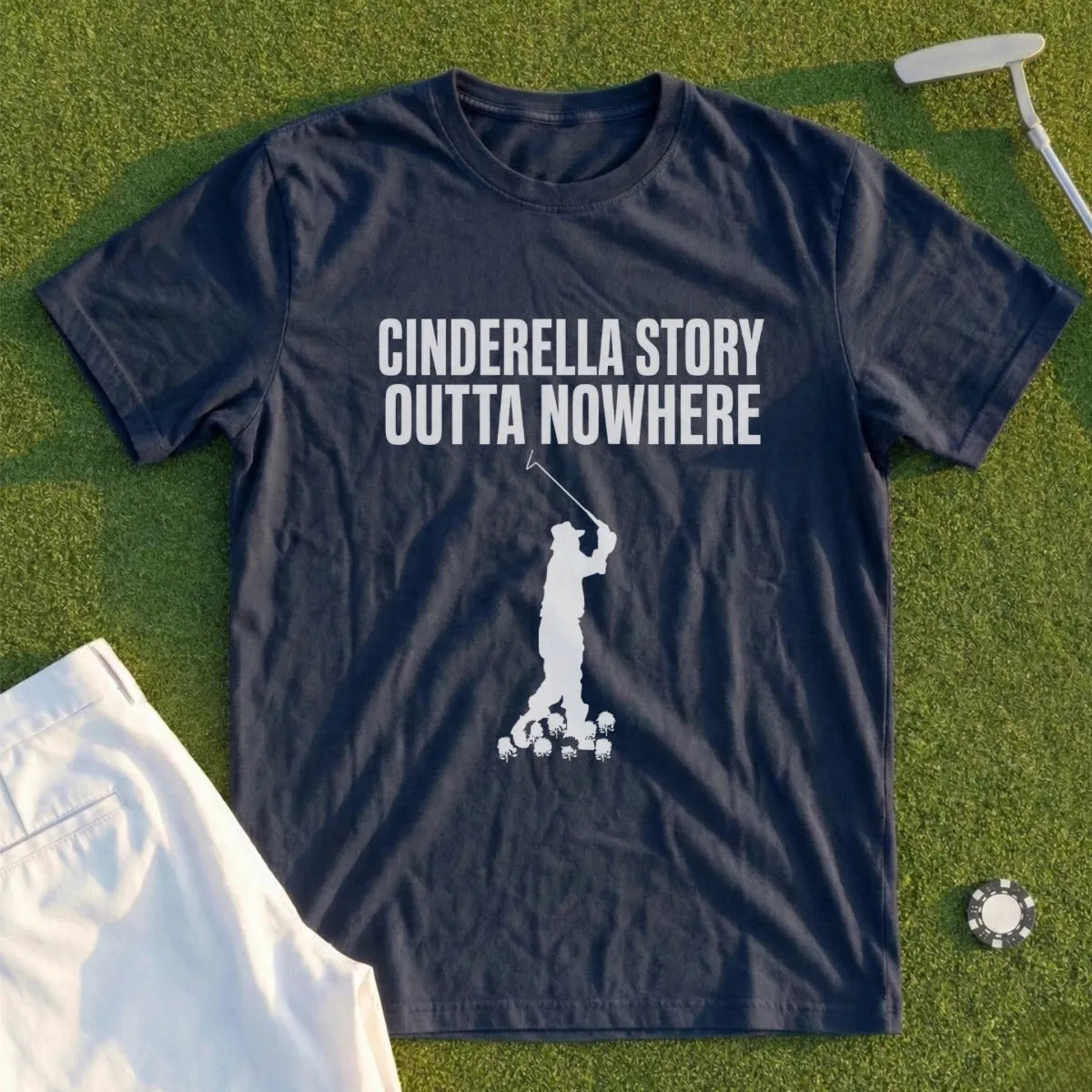 Dark blue t-shirt with text "CINDERELLA STORY OUTTA NOWHERE" and a golfer graphic.