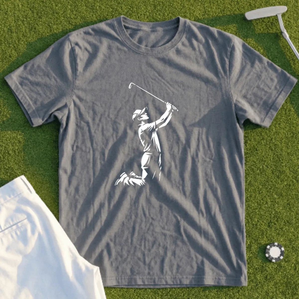 Gray t-shirt with white silhouette of a golfer swinging, on green grass.