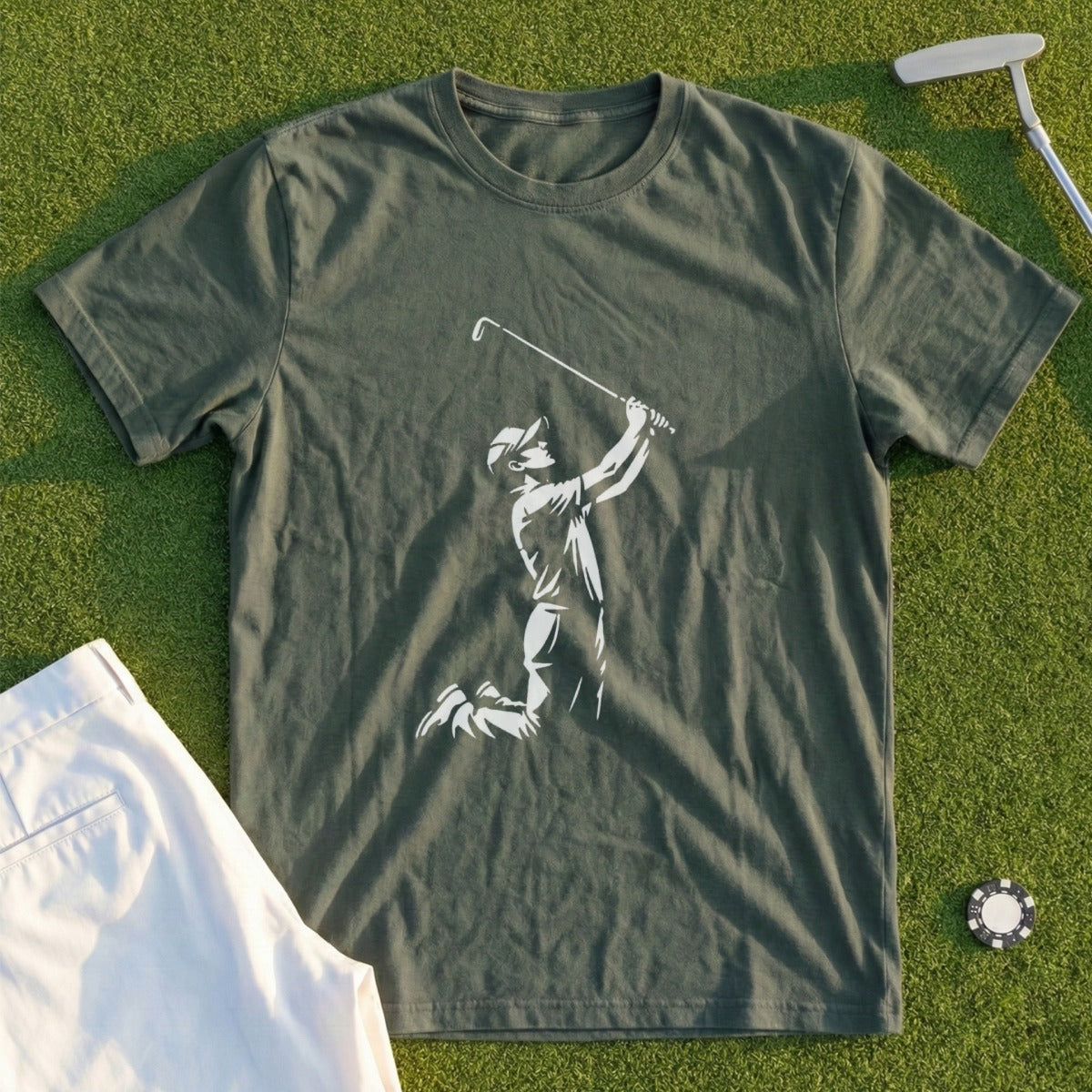 Green t-shirt with golfer silhouette in action, white shorts, and golf ball.