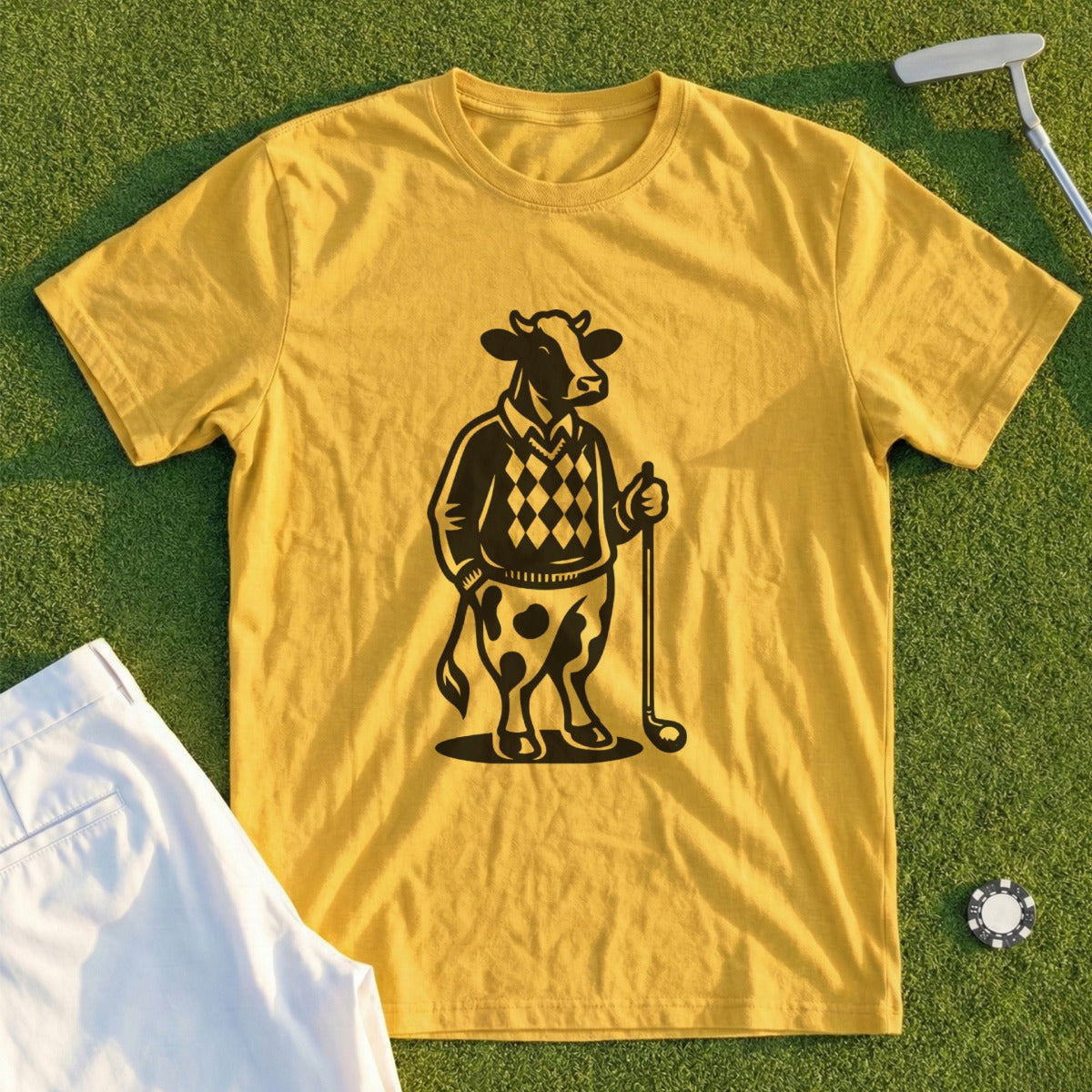 Yellow t-shirt with black graphic of a cow wearing a sweater and holding a golf club.