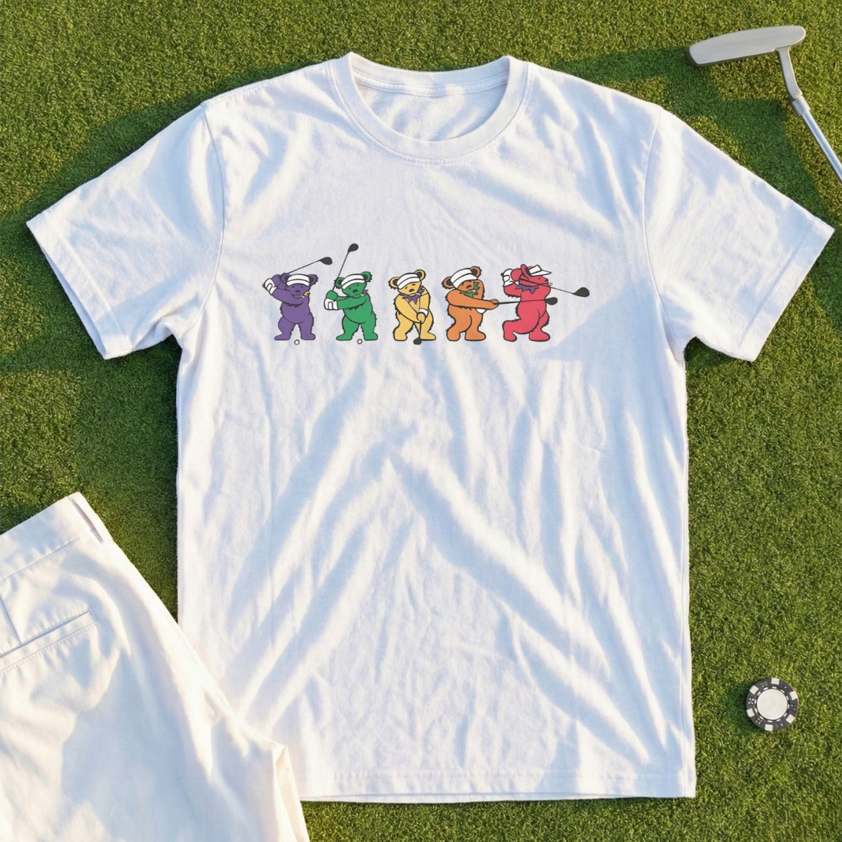 White t-shirt with cartoon bears playing golf.