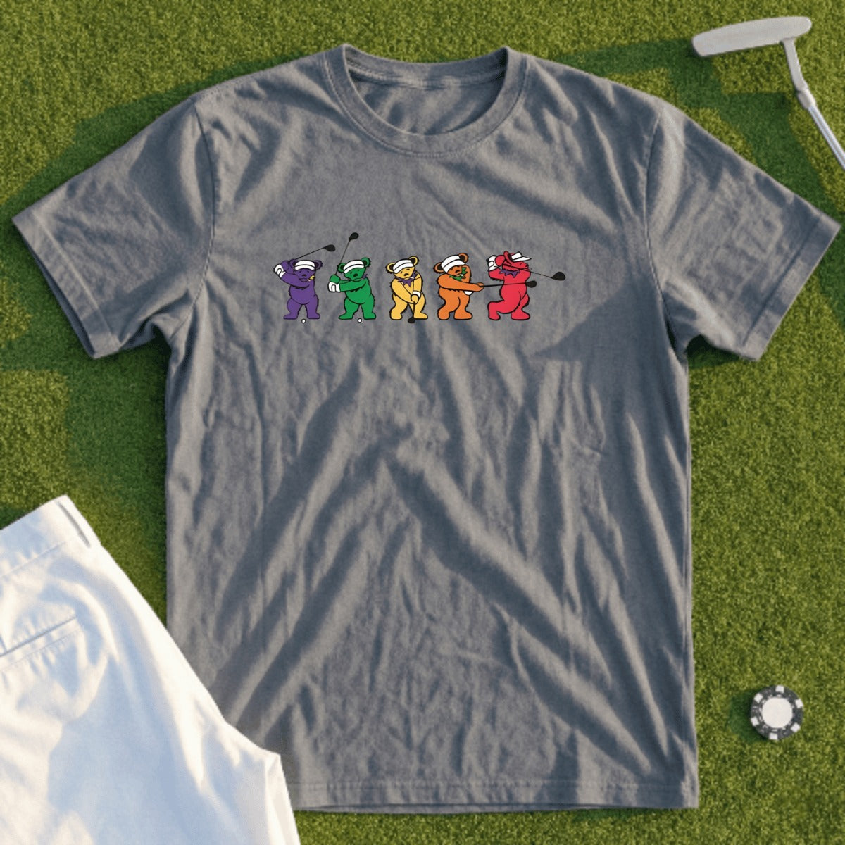 Gray t-shirt with cartoon bears playing golf, white shorts, and a golf ball.