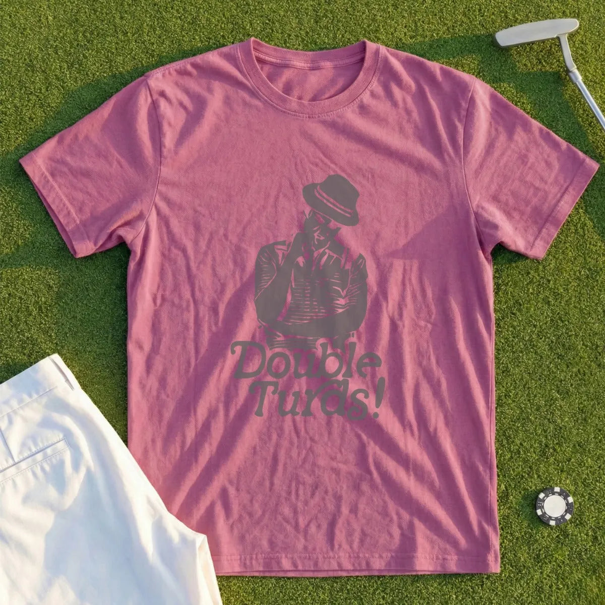 Pink t-shirt with "Double Turds!" graphic and man wearing a hat.