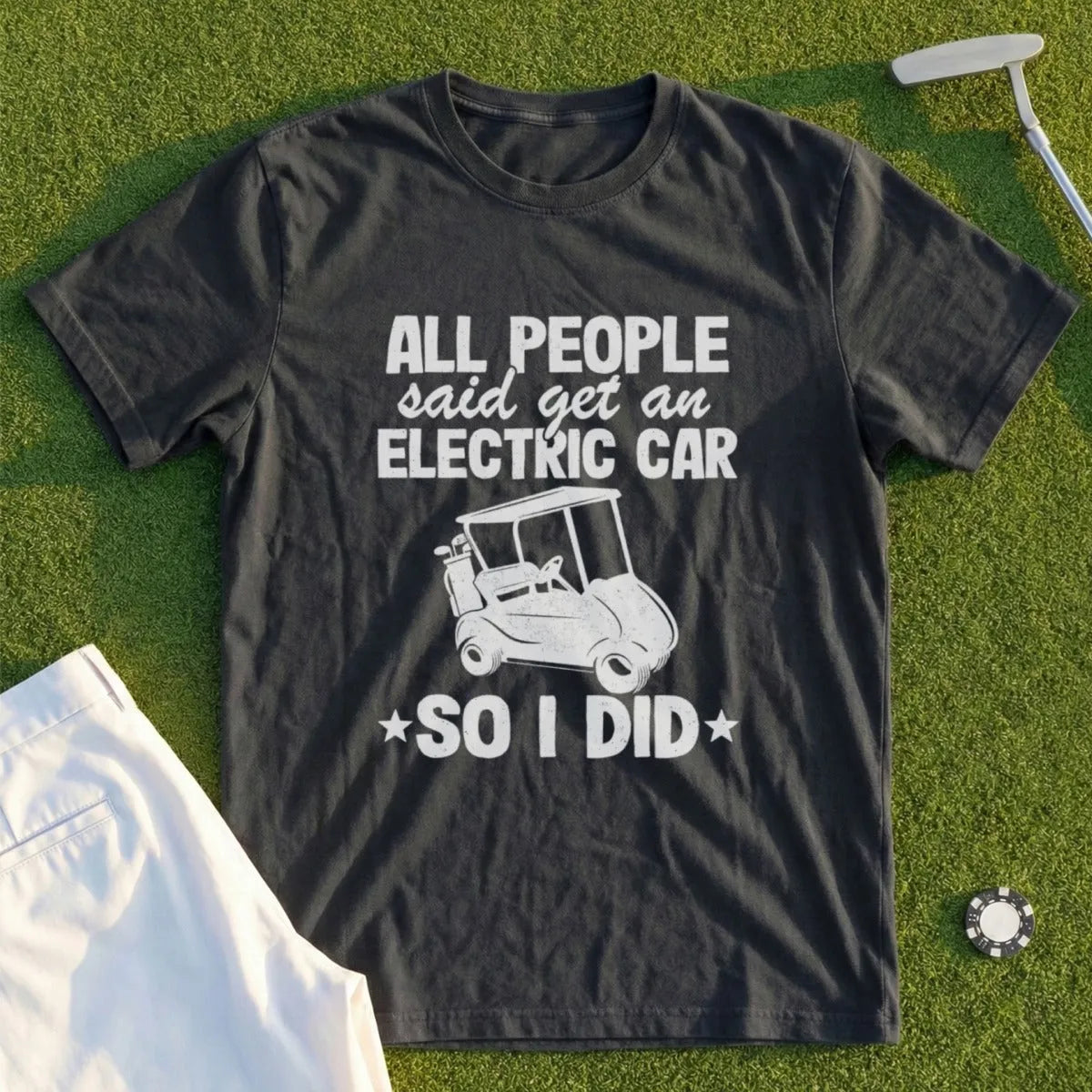 Dark t-shirt with white text: "All people said get an electric car, so I did" and a golf cart graphic.