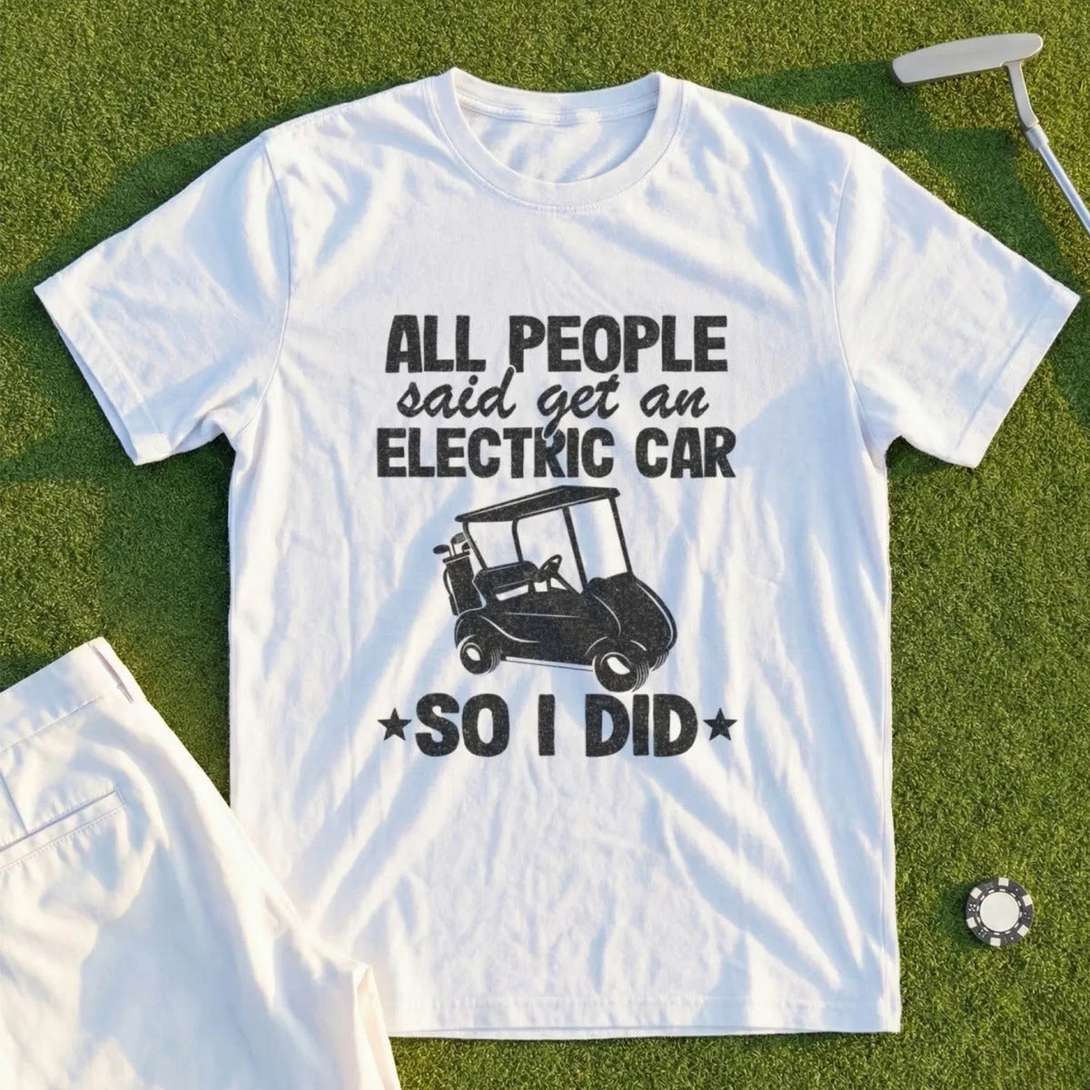 White t-shirt with "All people said get an electric car so I did" and a golf cart graphic.