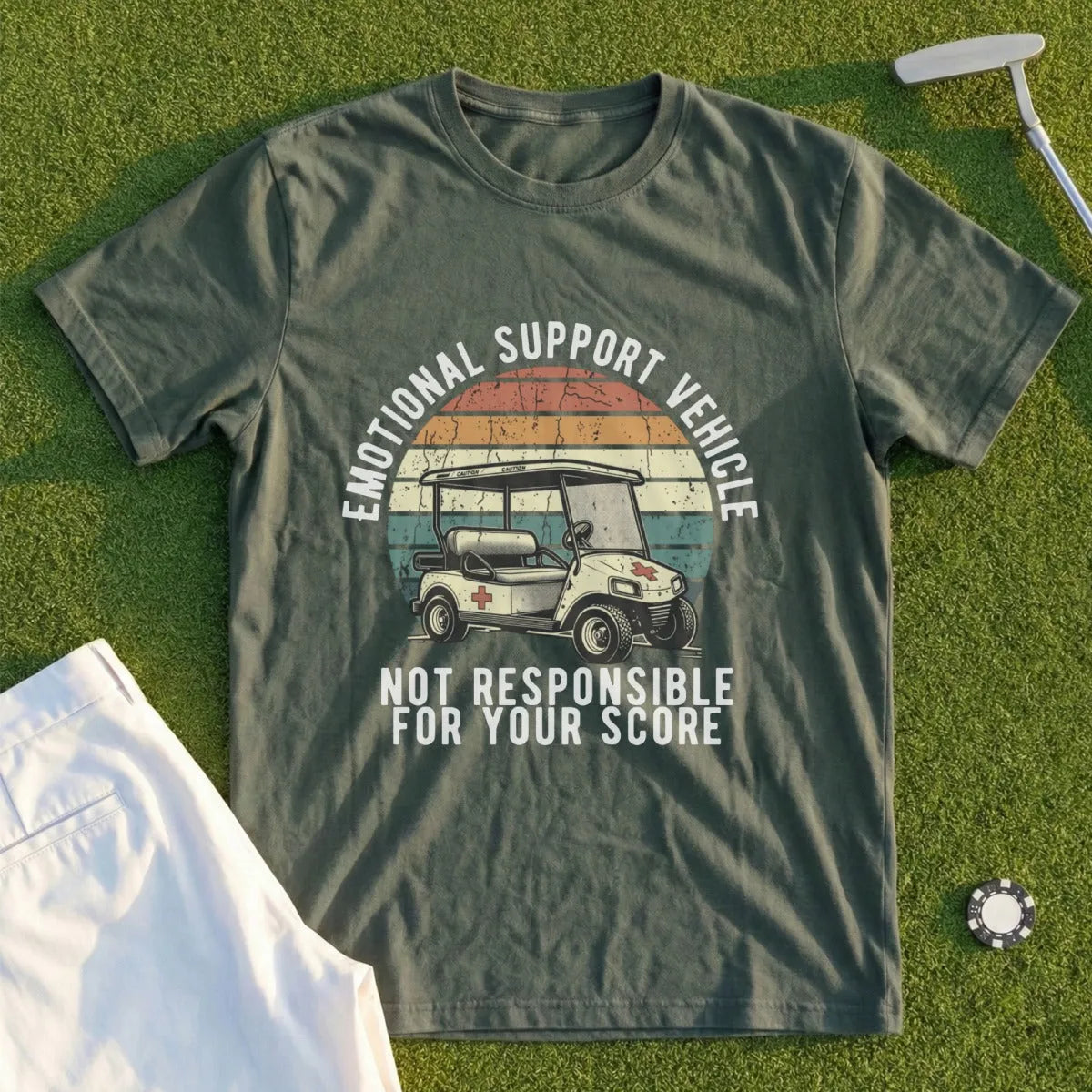 Green t-shirt with golf cart graphic and text "EMOTIONAL SUPPORT VEHICLE NOT RESPONSIBLE FOR YOUR SCORE".