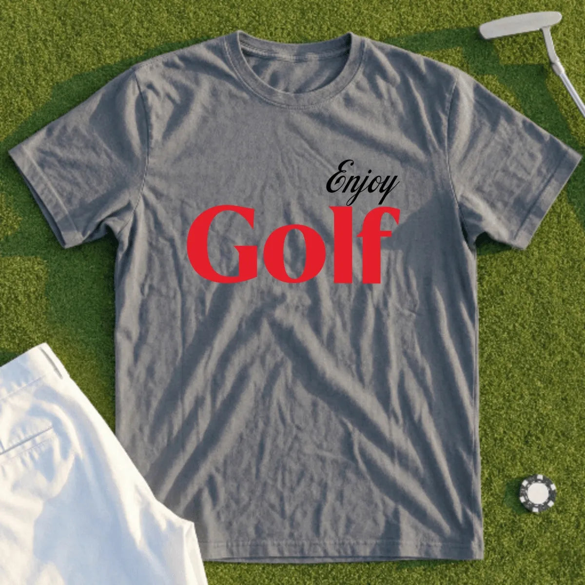 Gray t-shirt with "Enjoy Golf" text, displayed with golf accessories.