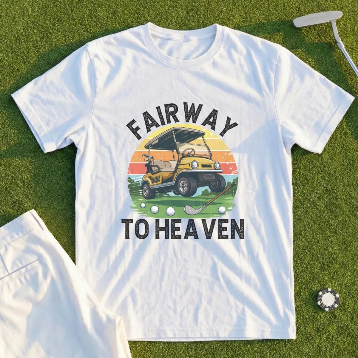 White t-shirt with "Fairway to Heaven" text, golf cart, and sunset graphic.