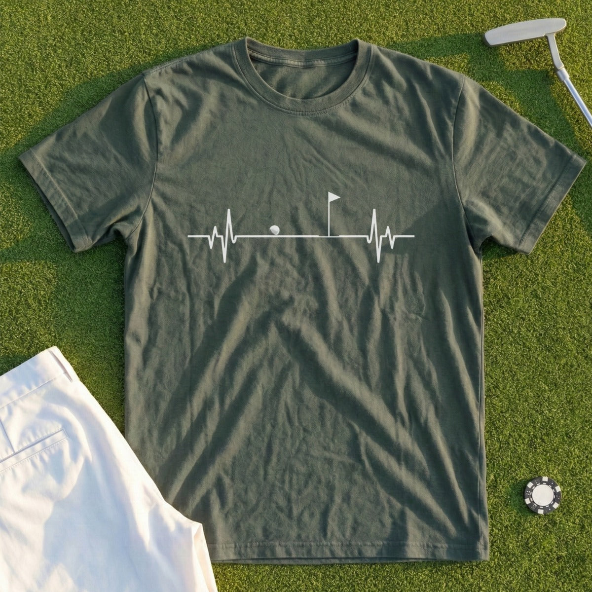 Green t-shirt with golf heartbeat graphic and white shorts.