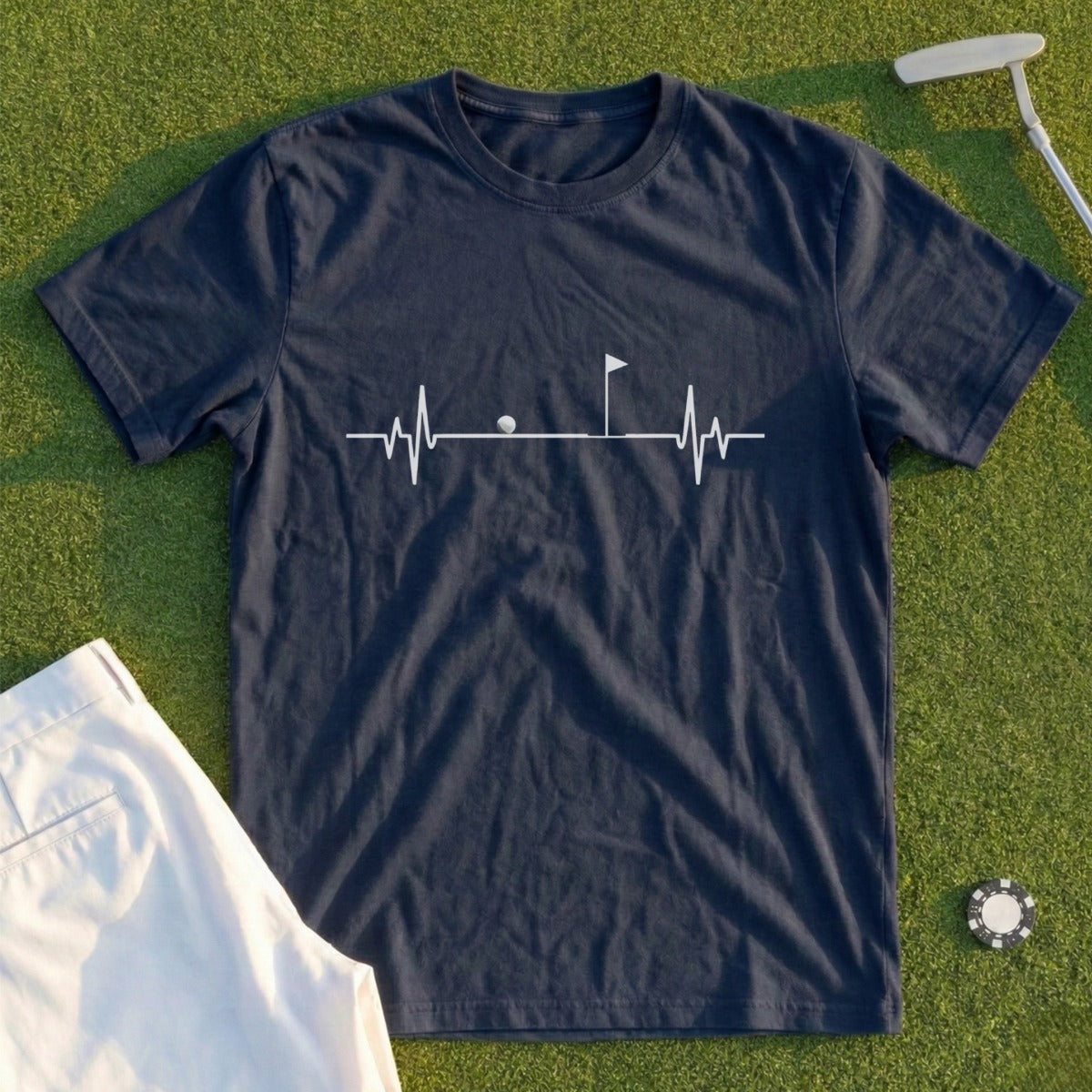 Dark blue t-shirt with a white golf heartbeat graphic and white shorts.