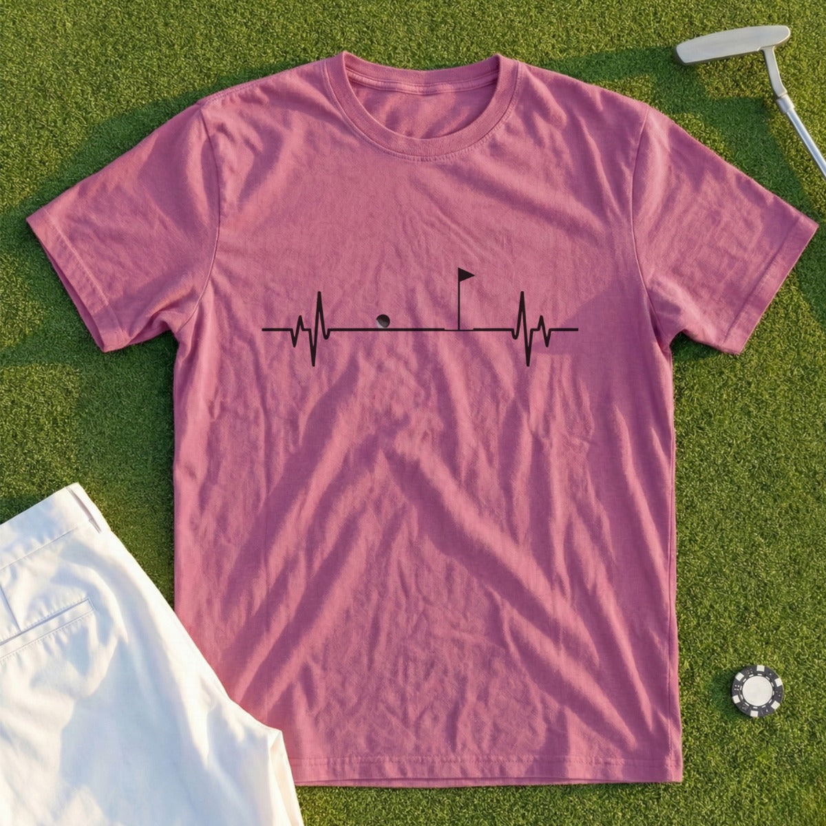 Pink t-shirt with a golf heartbeat graphic and a golf tee.
