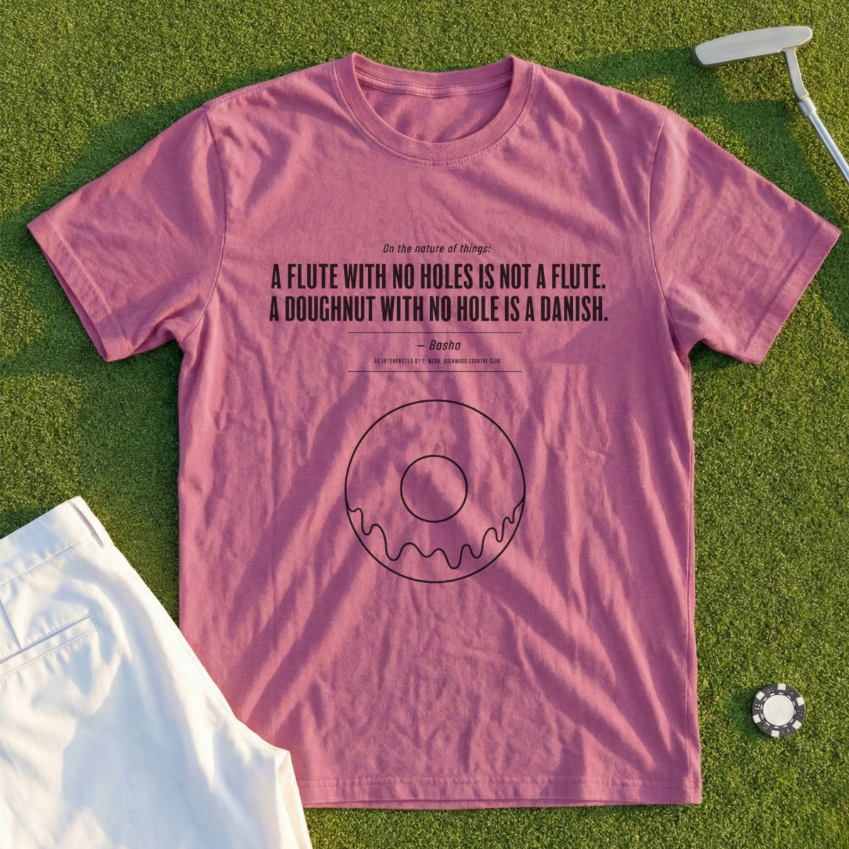 Pink t-shirt with black text and donut graphic.