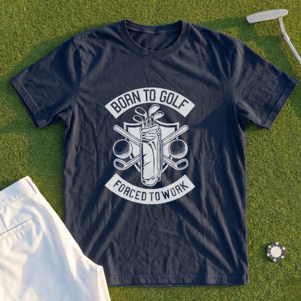 Dark blue t-shirt with "Born to Golf Forced to Work" graphic and golf accessories.