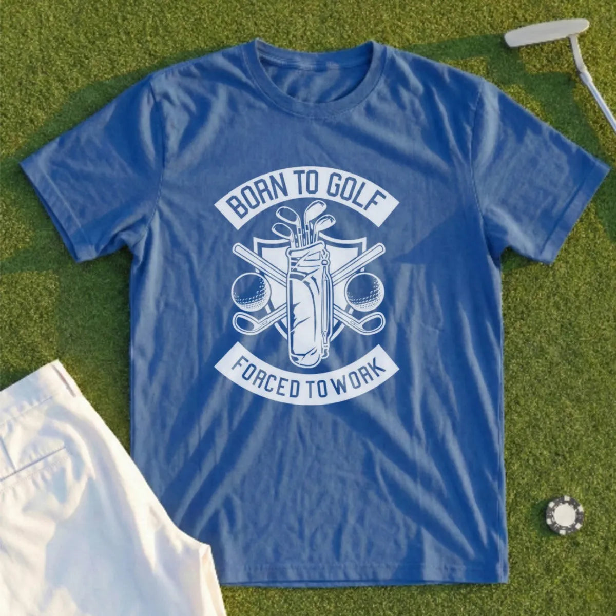 Blue t-shirt with "Born to Golf Forced to Work" graphic and golf accessories.