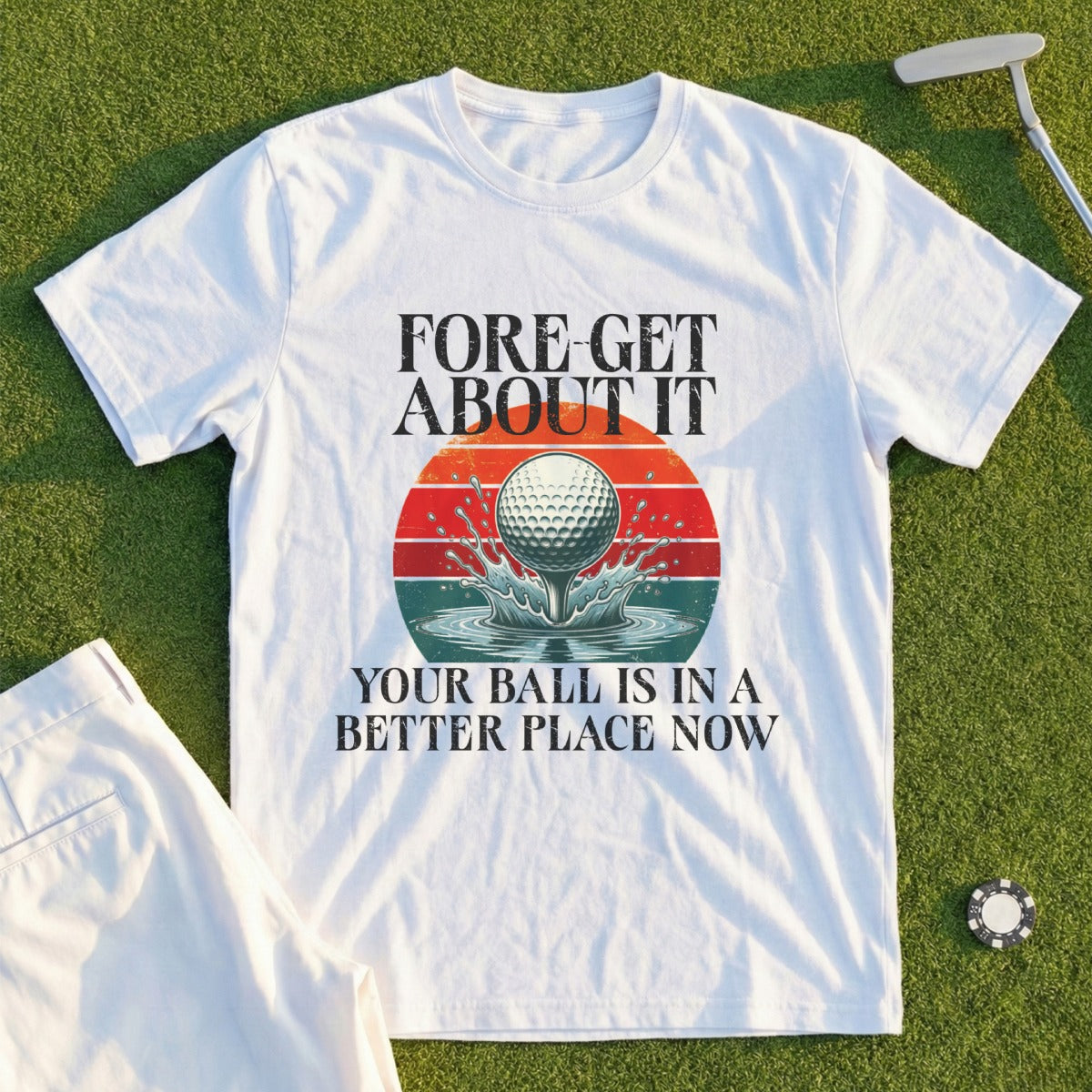 White t-shirt with "Fore-get it" and golf ball splashing water text.