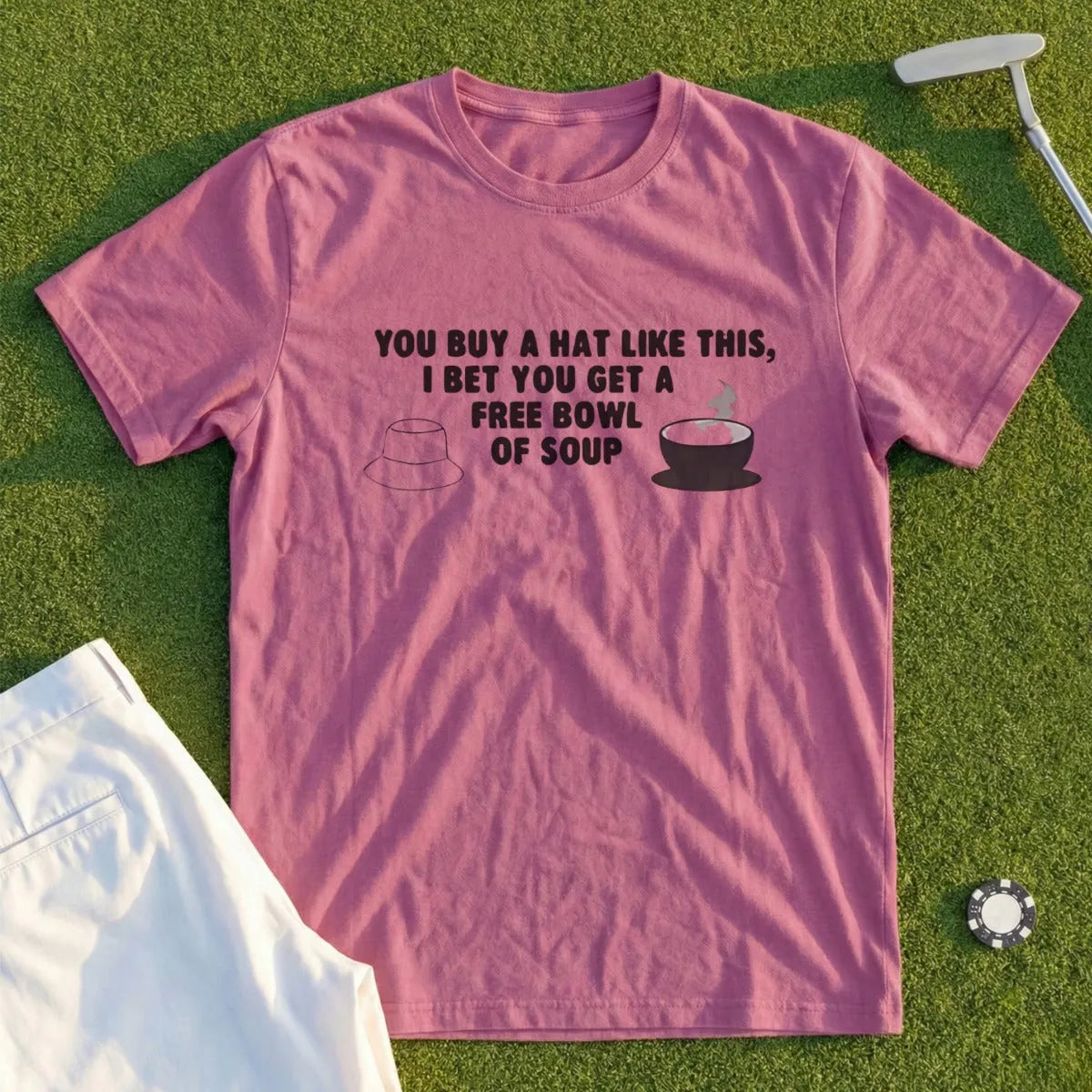 T-shirt with text "YOU BUY A HAT LIKE THIS, I BET YOU GET A FREE BOWL OF SOUP" and hat graphic.