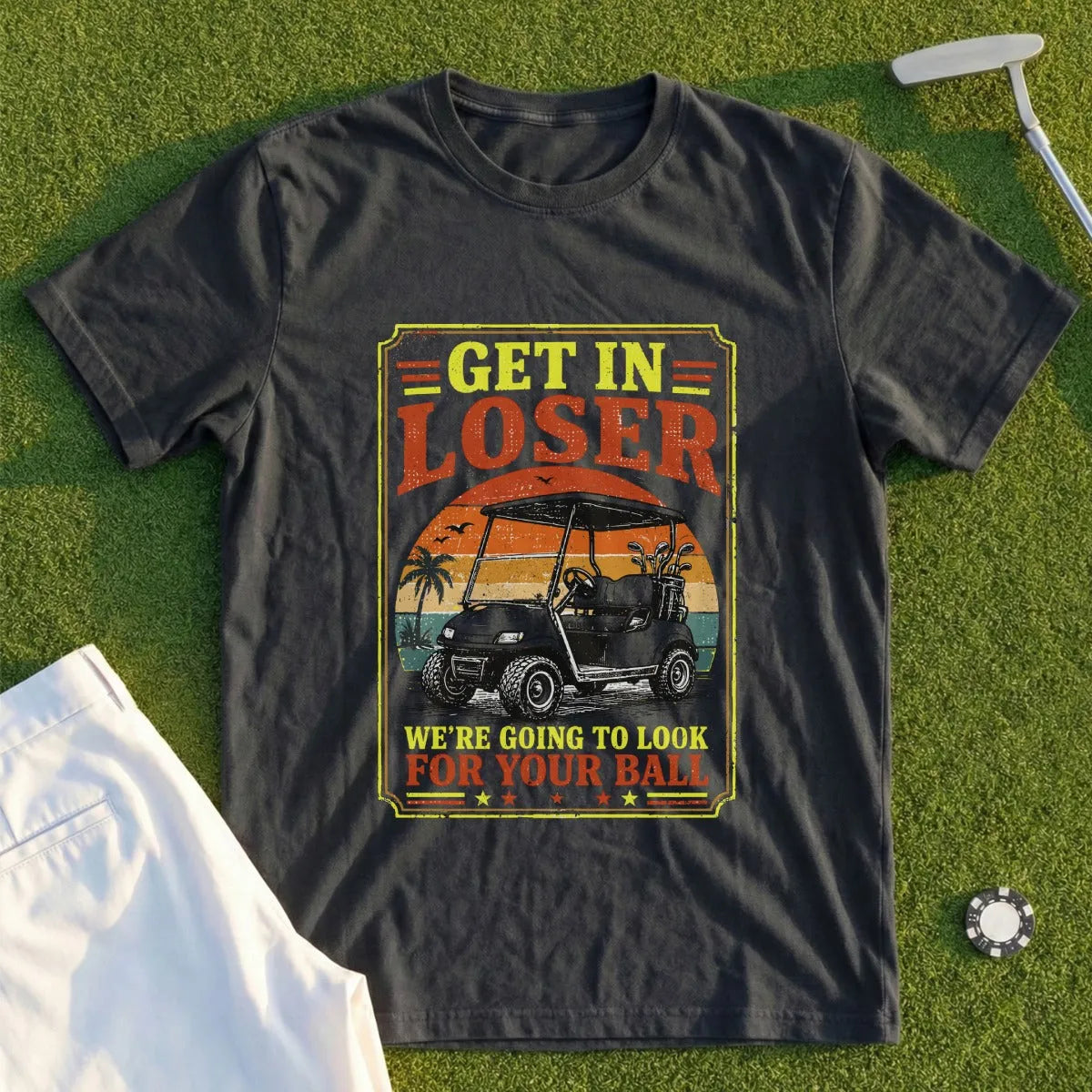 T-shirt with graphic of golf cart and text "Get in loser we're going to look for your ball."