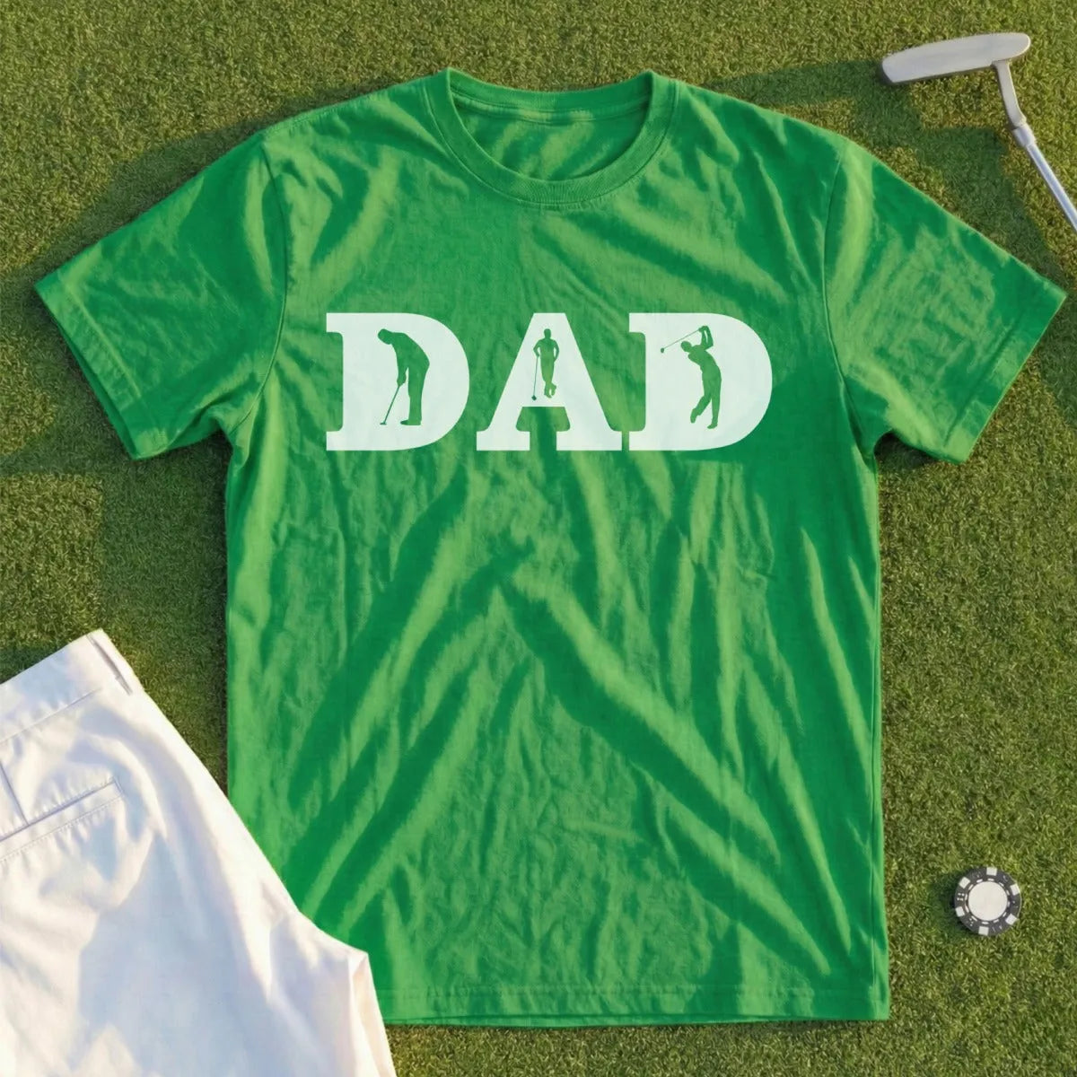 Green t-shirt with "DAD" in white silhouettes of golfers.