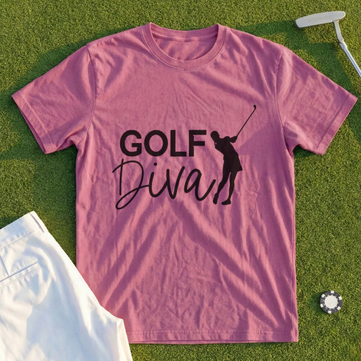 Pink t-shirt with "Golf Diva" text and golfer graphic, with golf accessories.