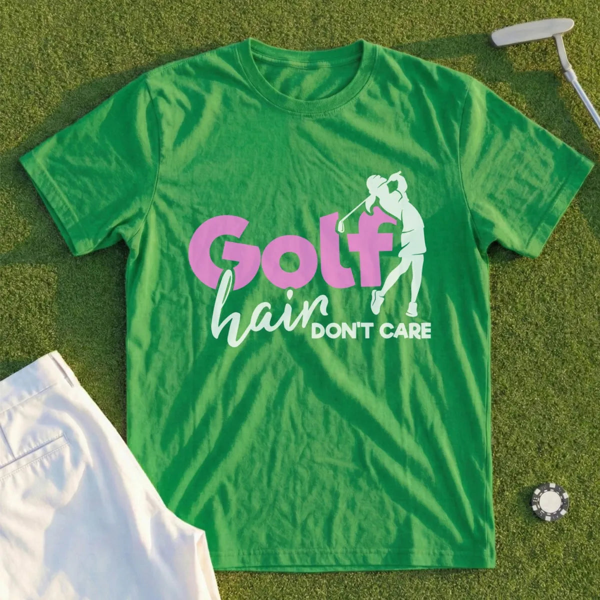 Green t-shirt with "Golf hair DON'T CARE" graphic on grass.