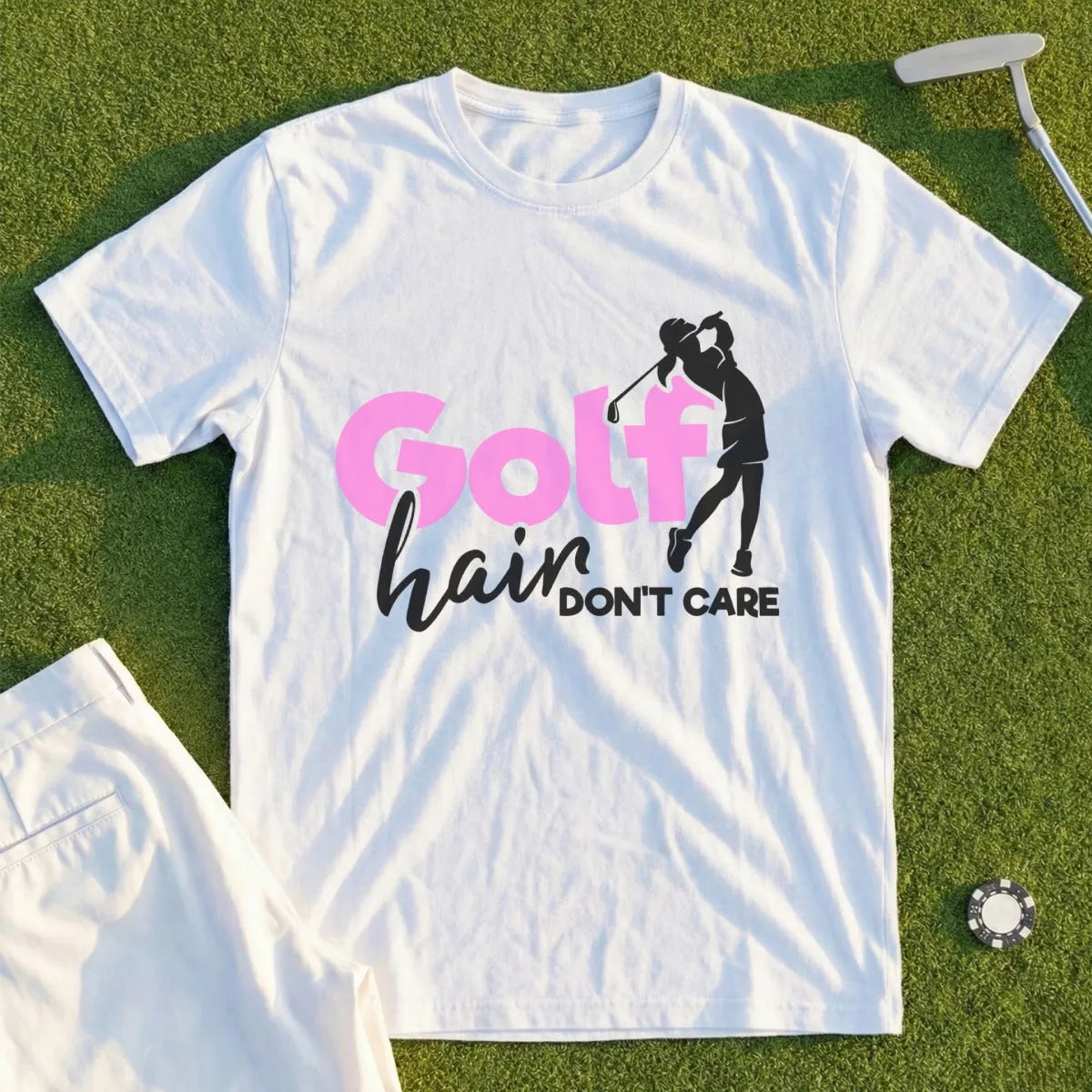 White t-shirt with "Golf hair don't care" graphic and golfer silhouette.