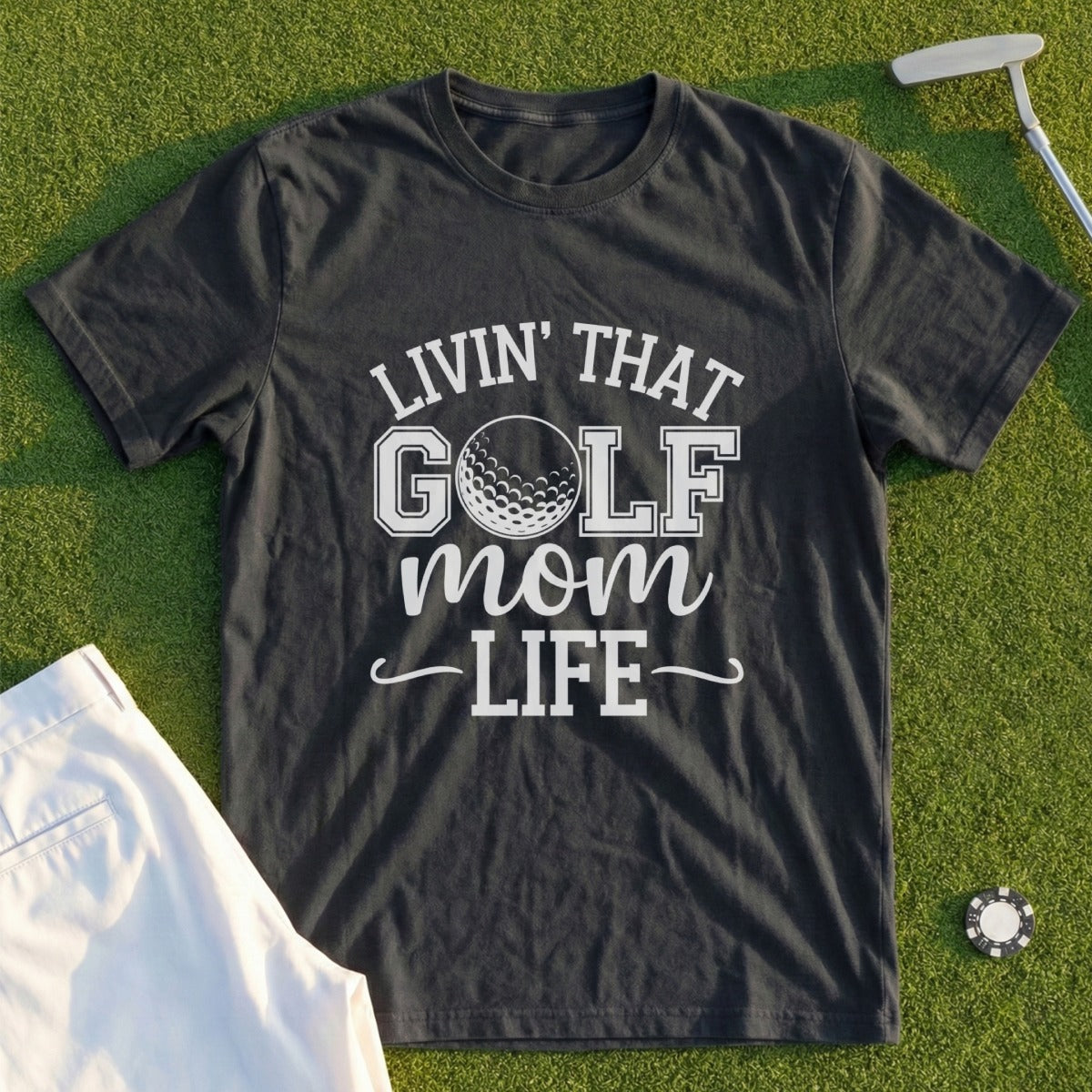 Dark t-shirt with "Livin' That Golf Mom Life" text and golf ball graphic.