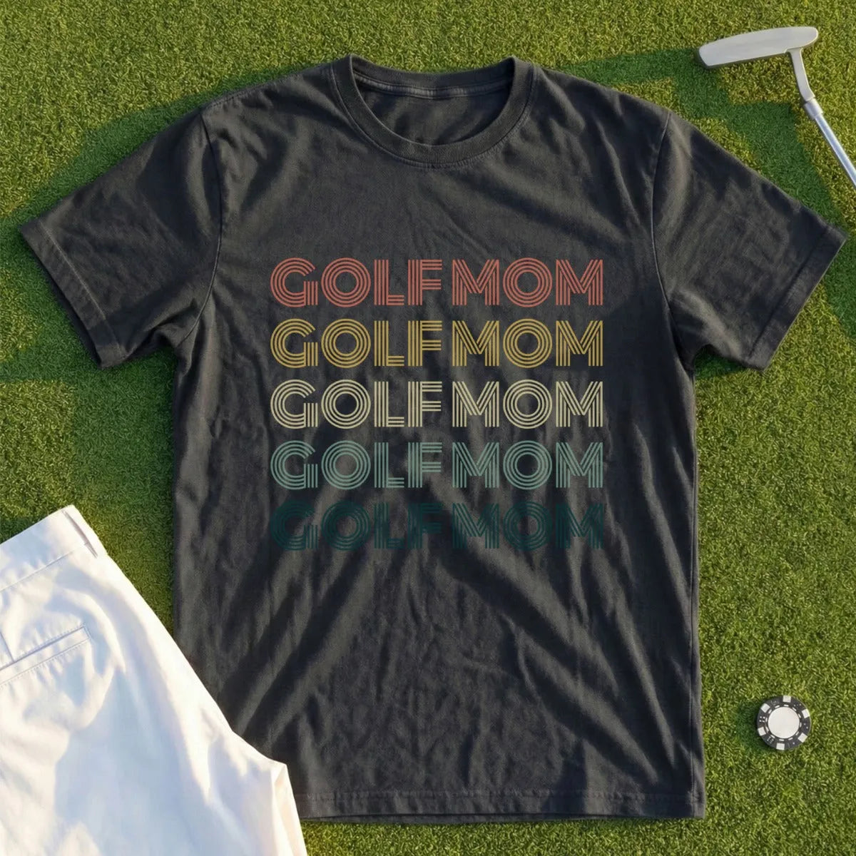Dark t-shirt with "GOLF MOM" text in retro stripes.