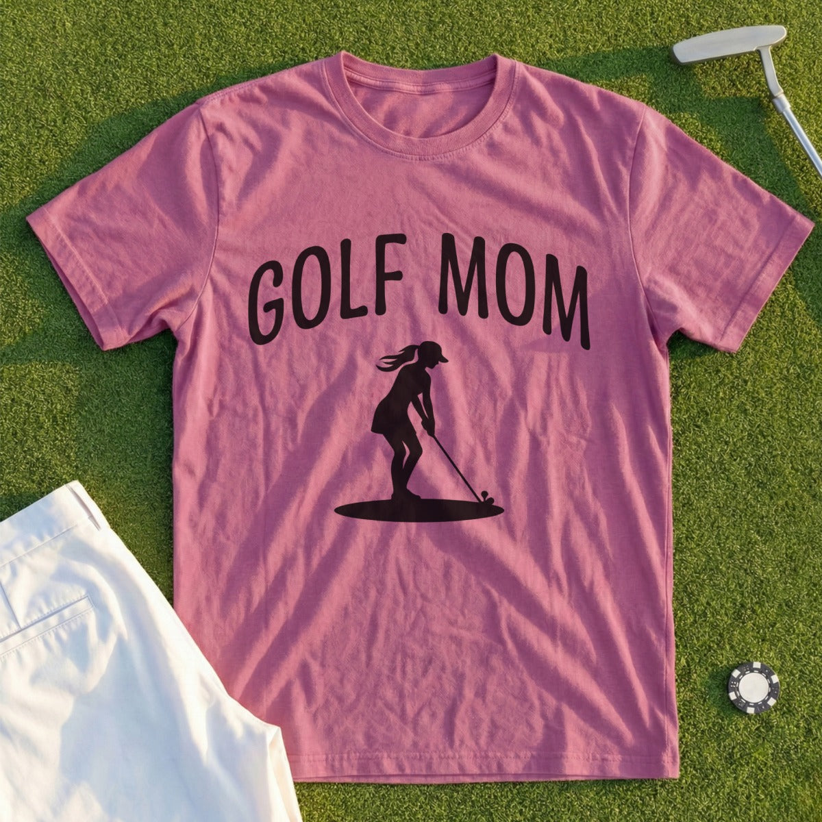 Pink t-shirt with "GOLF MOM" text and silhouette of a woman golfing.