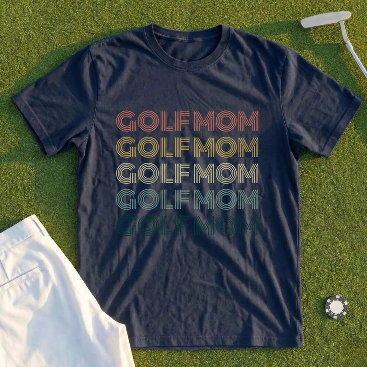 Navy t-shirt with "GOLF MOM" in retro stripes of yellow, orange, red, and green.