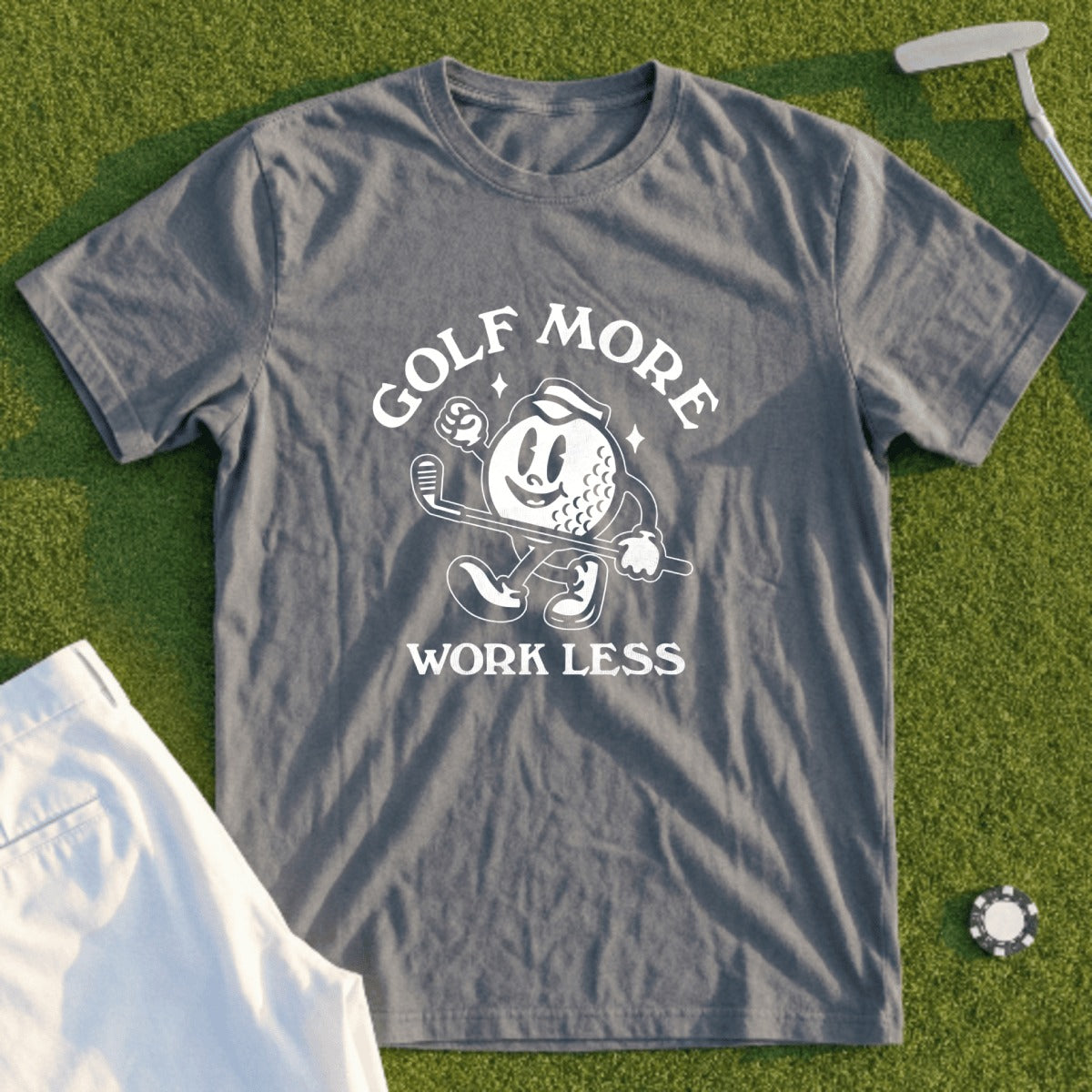 GOLF MORE WORK LESS graphic t-shirt with cartoon golf ball.