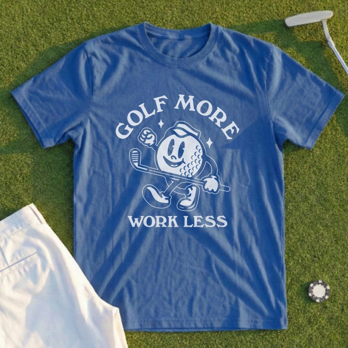 Blue t-shirt with "Golf More Work Less" text and cartoon golf ball.