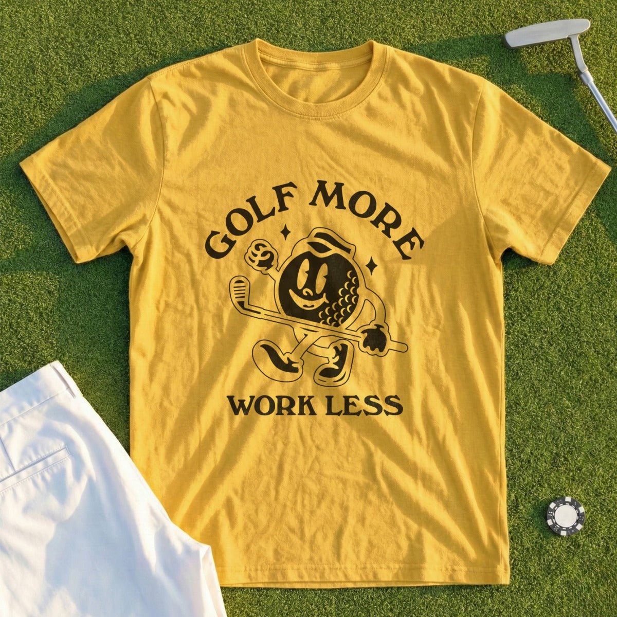 Yellow t-shirt with "Golf More Work Less" graphic and cartoon golf ball.