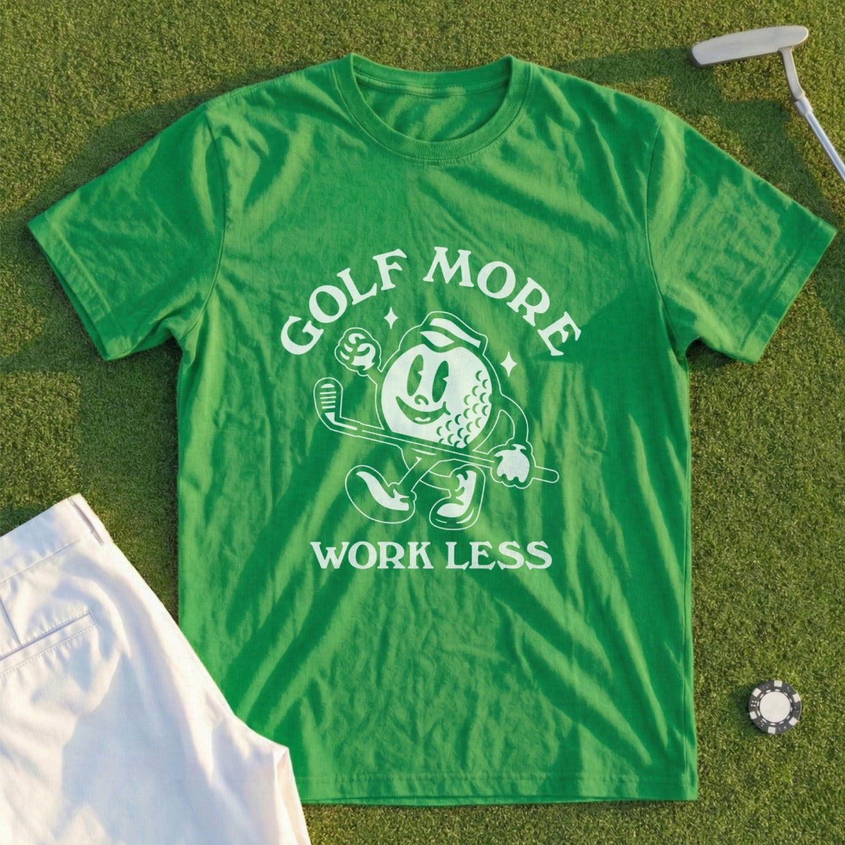 Green t-shirt with "GOLF MORE WORK LESS" text and cartoon golf ball character.