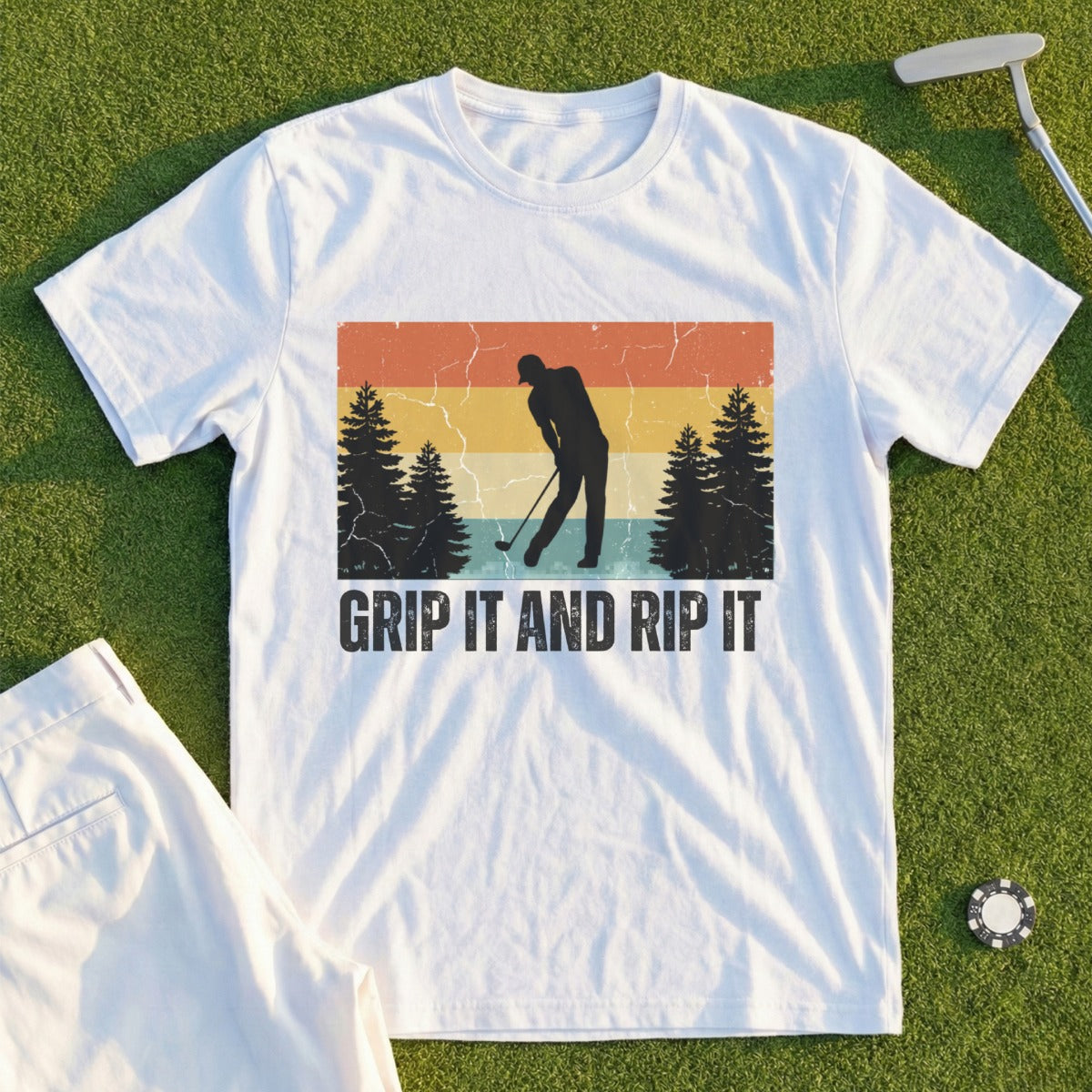 T-shirt with a golfer silhouette and "GRIP IT AND RIP IT" text against a vintage sunset.
