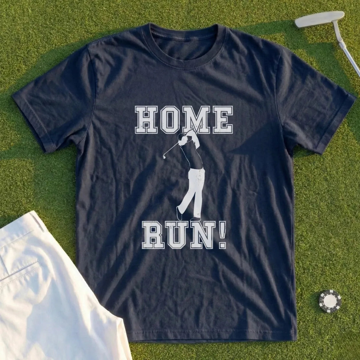 Navy t-shirt with "HOME RUN!" and golfer graphic on green grass background.
