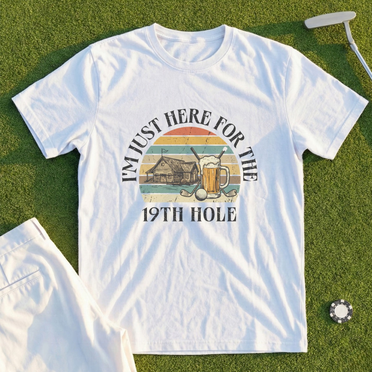 White t-shirt with "I'm just here for the 19th hole" and golf imagery.