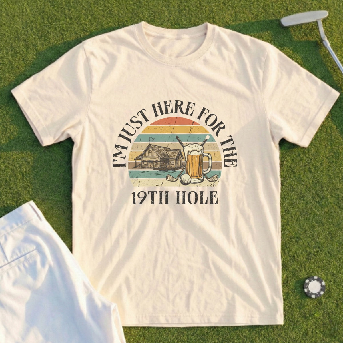 Cream t-shirt with "I'm Just Here for the 19th Hole" text and graphic.