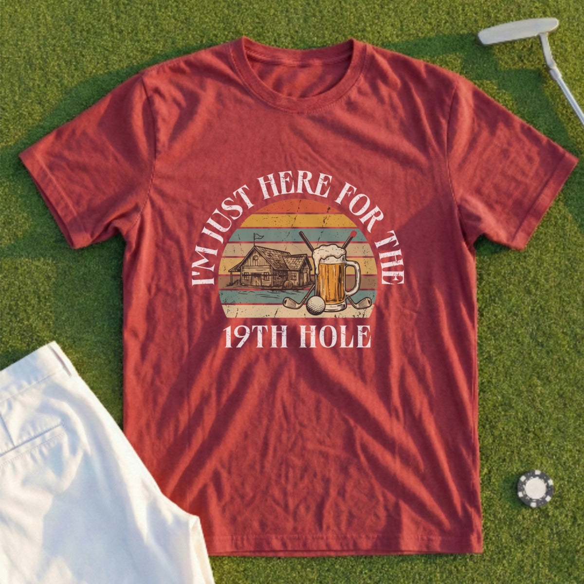Red t-shirt with "I'M JUST HERE FOR THE 19TH HOLE" text and golf-themed illustration.