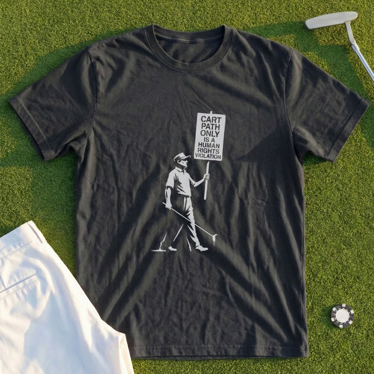 Dark t-shirt with graphic of golfer holding sign "CART PATH ONLY IS HUMAN RIGHTS VIOLATION".