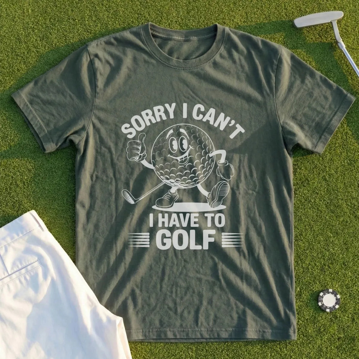 Green t-shirt with cartoon golf ball saying "Sorry I Can't, I Have To Golf".