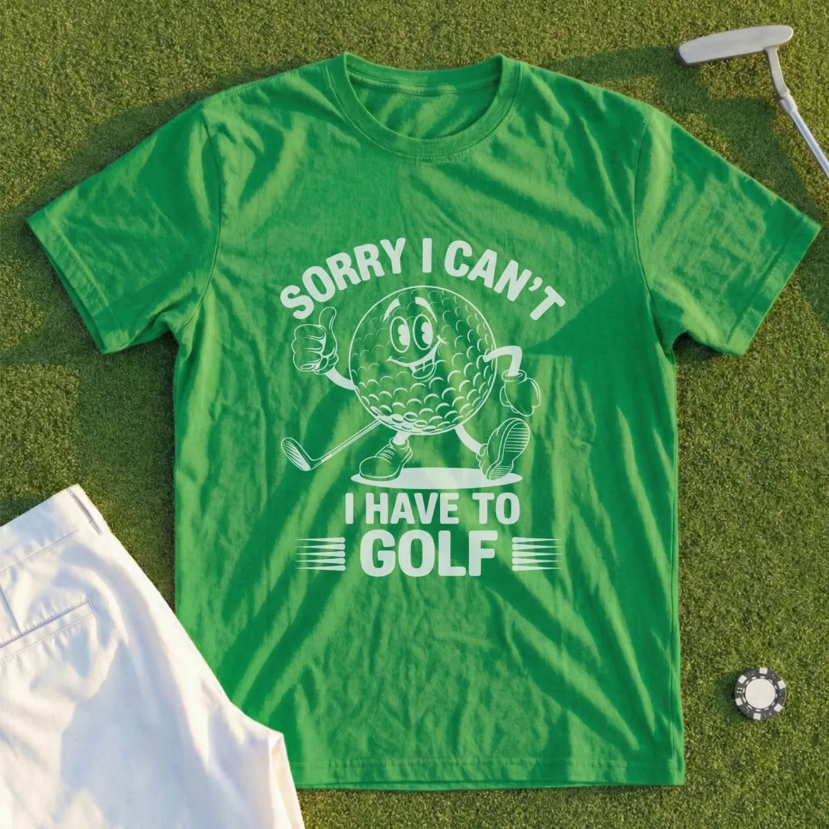 Green t-shirt with cartoon golf ball saying "Sorry I can't have to golf."