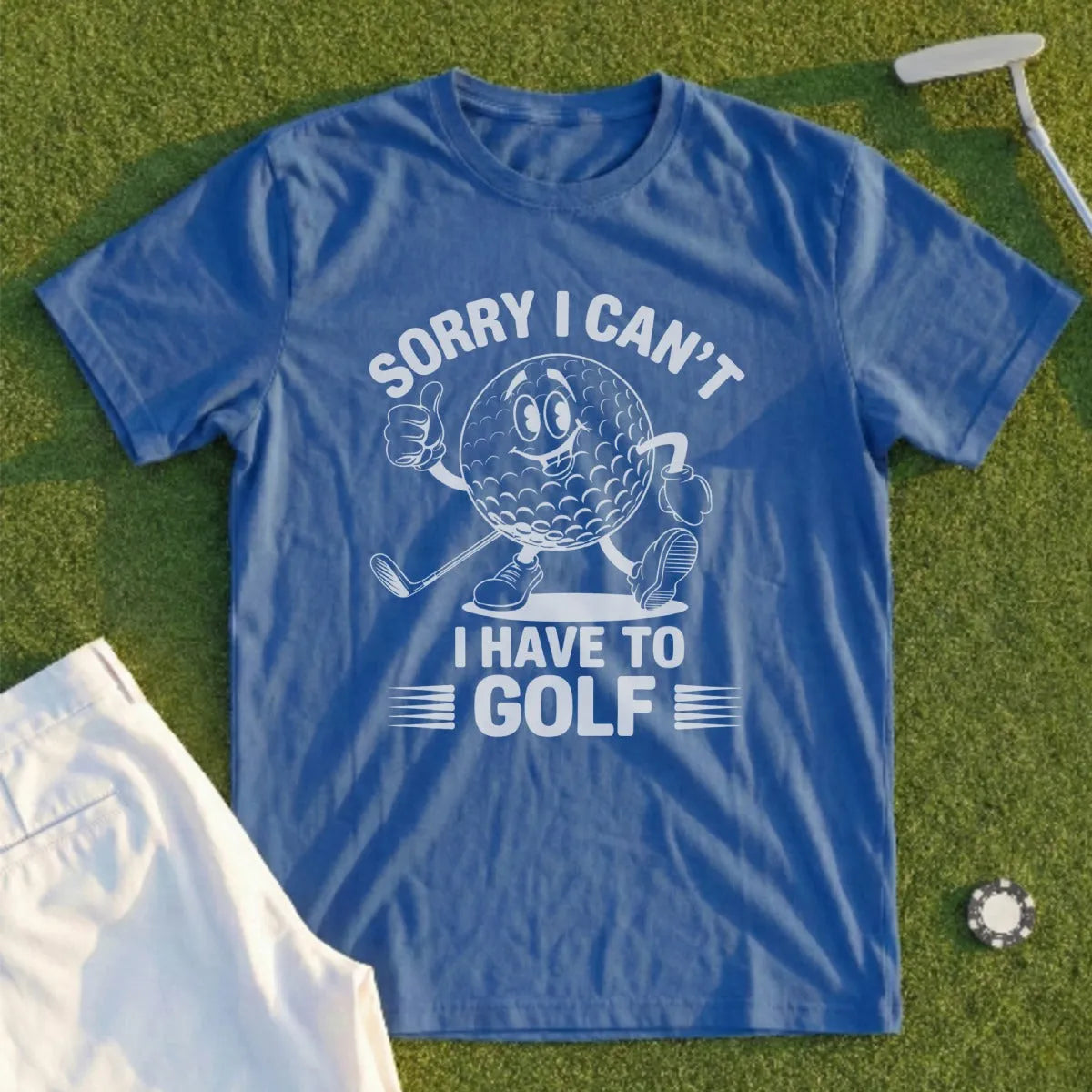 Blue t-shirt with a cartoon golf ball stating "Sorry I can't I have to golf".