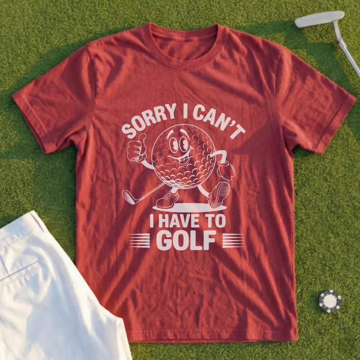 Maroon t-shirt with cartoon golf ball saying "Sorry I can't have to golf".