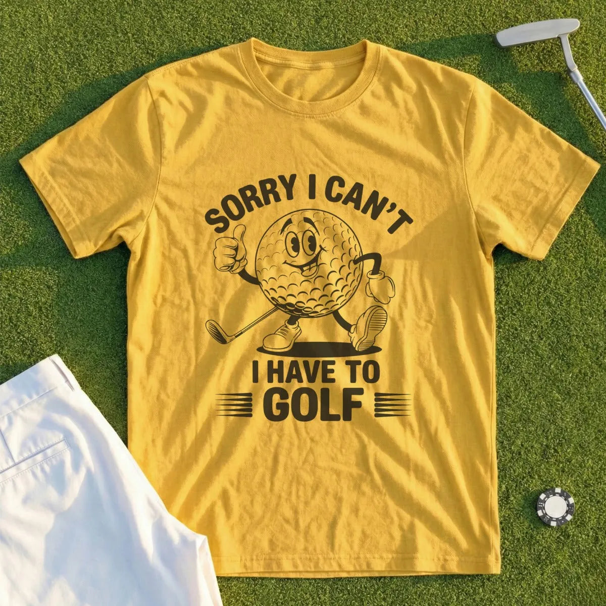 Yellow t-shirt with cartoon golf ball and text "Sorry I Can't I Have To Golf".