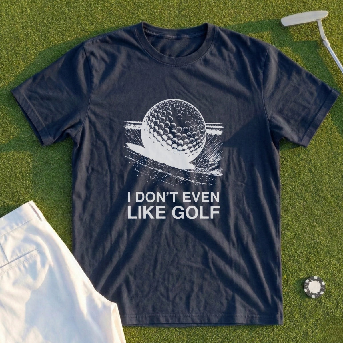 Navy t-shirt with a golf ball and text "I DON'T EVEN LIKE GOLF".