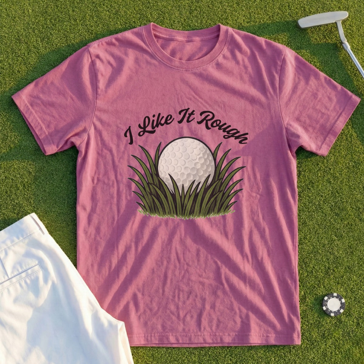 Pink t-shirt with "I Like It Rough" text over a golf ball in grass.