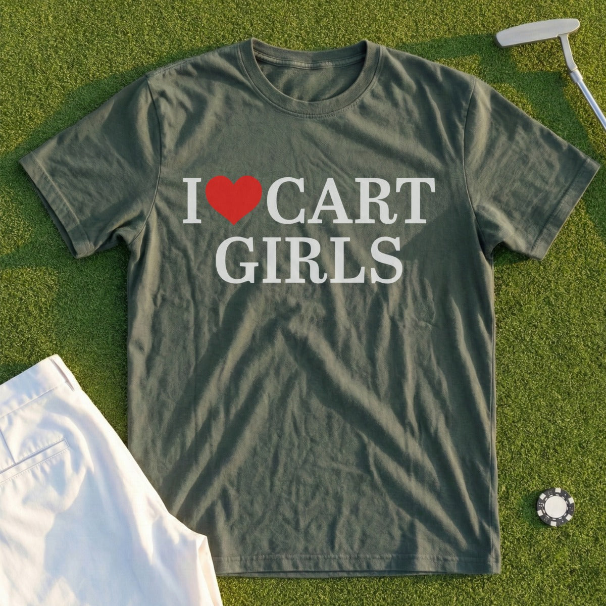 Olive green t-shirt with "I ❤️ CART GIRLS" text, laid flat on grass.
