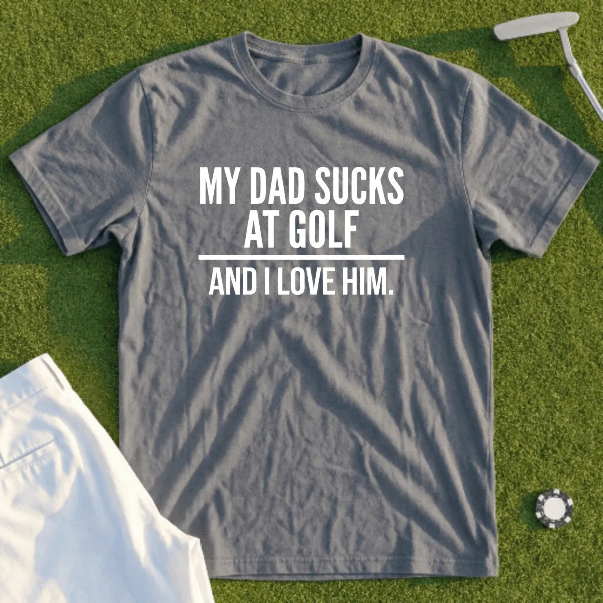 Gray t-shirt with "MY DAD SUCKS AT GOLF AND I LOVE HIM." text.