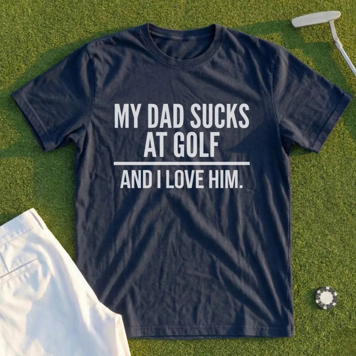 Navy t-shirt with white text: "MY DAD SUCKS AT GOLF. AND I LOVE HIM."